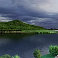 Scenic Landscape Featuring Green Hills Long White Bridge Calm Lake Trees And Dark Clouds Sky