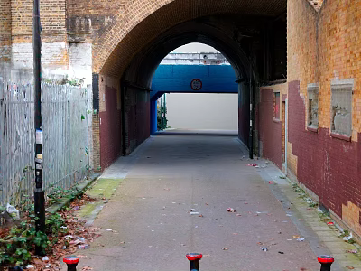 Brick Archway Passageway Featuring Walls Wooden Fence Leaves Trash Blue White Wall Clock Red Bollards 3d model
