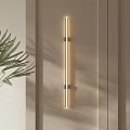 Modern Elongated Wall Light With Warm LED Glow Beside Green Leaf Plant In Home