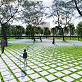 Garden Ornament With Grid Patterned Tiles Green Lawn And Trees For Walking
