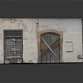 Old Weathered Building Facade With Wooden Doors Weathered Walls And Stone Steps