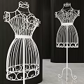 White Mannequins With Intricate Decorative Design Standing Against Black Background
