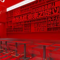 Vibrant Red Interior With Text Covered Walls And Matching Tables Chairs