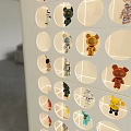 Stylish Figure Cabinet Displaying Diverse Collectible Figures On Grid Shelves Modern Living Room