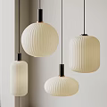 Three Pleated Pendant Lights with White Lampshades and Black Bases Hanging