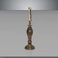 Decorative Brass Candlestick With Tall Design And Lit Candle On Black Surface