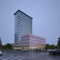 Modern High Rise Office Building With Glass Facade Surrounding Low Rise Structure And Parking Area