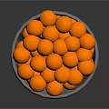 Grey Woven Basket Filled With Round Orange Decorative Balls On Dark Surface