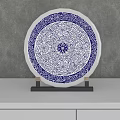 Blue And White Floral Decorative Ornament Set On Black Stand With Gray Wall
