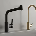 Modern Black And Gold Faucets On White Countertop With Grey Wall
