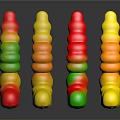 Colorful Gummy Worms With Red Yellow Green Smiley Face Shapes On Black Surface