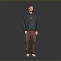 Man Wearing Dark Gray Hoodie With Brown Pants And White Shoes On Gray Background