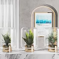 Transparent Glass Vases With Gold Bases Holding Green Plants In Modern Interior Decor
