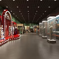Museum Exhibition Hall Featuring Red Display Stands Mannequins Glass Cases And Bright Lighting