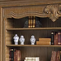 Classic Wooden Bookcase With Carved Top And Shelves Filled With Books Vases And Decorative Items