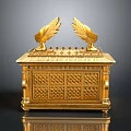 Golden Ornate Chest With Wing Decorations And Intricate Carved Patterns On Reflective Base