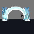 Blue Decorative Archway With Repeated Logos Illuminated Marine Decor And Person Standing Nearby