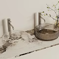 Modern Textured Glass Washbasins With Metallic Faucets And Decorative Plant On Patterned Countertop