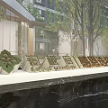 Elegant 3D Letters Signage at Building Entrance with Green Logo Trees and Water Feature