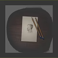 Portrait Sketch on Paper with Two Pencils on Wooden Table Surface