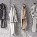 Minimalist Modern Coats In Dark Gray Light Gray And Beige Hanging On Gray Wooden Wall