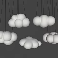 Cloud Shaped Chandeliers Hanging On Gray Wall With Soft White And Green Glow