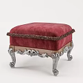 Elegant Red Ottoman With Fringed Trim And Ornate Silver Carved Legs