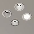 Four Recessed Ceiling Lights With White And Gray Trim On Gray Ceiling