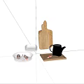 Carved Wooden Cutting Board With Black Kettle And Glass Bowls In Kitchen Setup