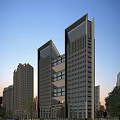 Elegant Modern High Rise Office Building Exterior With Glass Curtain Walls And Evening Lighting