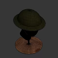 Green Military Style Helmet With Wide Brim And Brown Strap On Mannequin Head