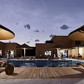 Earth Toned Guesthouse Building With Swimming Pool Thatched Umbrellas Wooden Deck And People Relaxing
