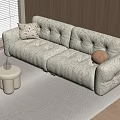 Beige Tufted Double Sofa With Patterned Cushion Round Pillow On Light Gray Rug Wooden Wall
