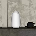 Modern White Illuminated Table Lamp with Black Mug and Textured Gray Wall Background