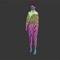 Woman In Colorful Printed Top And Pants Standing Stylishly Against Gray Background
