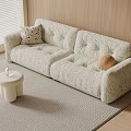 Two Seater Sofa With Textured Fabric Decorative Pillows Small Stool And Soft Rug