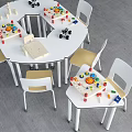 Round Table And White Chair Set With Yellow Seats Building Blocks In Kids Play Area