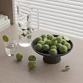 Fresh Green Limes in Black Bowl with Glass Pitcher and Mint Leaves on Wooden Table