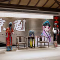 Traditional Peking Opera Costume Display With Red Lanterns And Cultural Elements