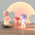 Astronaut Dolls With Sunset Inspired Circular Light Shadow Plant Books Stack And Round Lamp
