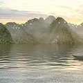 Peaceful Sunrise Lake Natural Landscape With Misty Green Hills Flying Birds And Small Wooden Boat