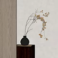 Black Textured Vase With Golden Leaf Branches On Square Wooden Stand Against Grey Wall