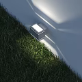 Modern Square Outdoor Light Illuminating Green Grass And Wall In Garden Area