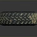 Muddy Off-Road Tire with Deep Tread Pattern and Black Wheel Rim