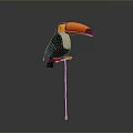 Toucan with Large Colorful Beak Perched on Golden Stand Against Grey Background
