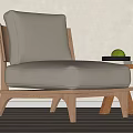 Comfortable Accent Chair with Beige Cushion Wooden Frame Beside Small Side Table Holding Green Apple