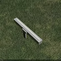 White Rectangular Outdoor Light with Stand Glowing on Green Grass Illuminating Lawn