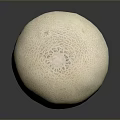 Fresh Cantaloupe With Textured Light Yellow Skin On Dark Reflective Surface