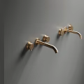 Two Golden Wall Mounted Faucets With Elegant Design On Grey Wall