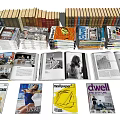 Various Stacked Books And Magazines With Diverse Covers Design Themes And Open Pages